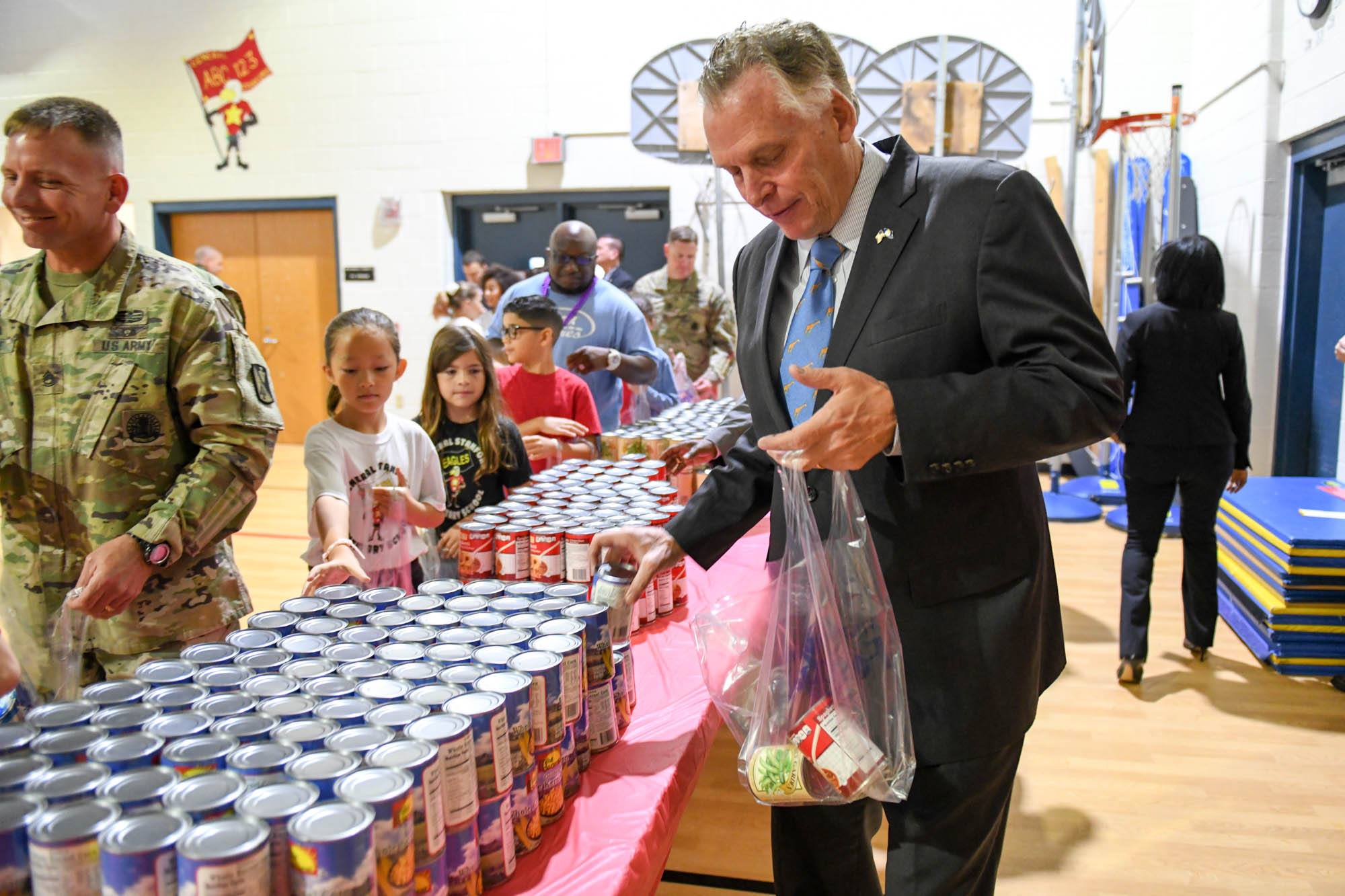 Gov-Terry McAuliffe-packing backpacks